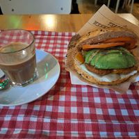 Oat milk coffee and falafel & avo bagel at Coffee & Bagel House in Berlin
