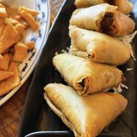 Burmese Gold Samosas: Crispy triangles filled with delicious stuffing made of potatoes, carrots and peas. Sizzled to perfection and served with house chili sauce.  at Top Burmese Burma Joy in Portland