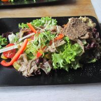 Salad with raw crackers and hummus at MO in Wroclaw