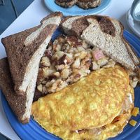 Special: butternut squash and feta omelette, rye toast, home fries; behind: soy sausage patties (all vegan)  at Smile of the Beyond in Jamaica