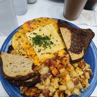 Vegan artichoke bacon frittata with provolone cheese, home fries, rye toast with vegan butter was delicious!! at Smile of the Beyond in Jamaica