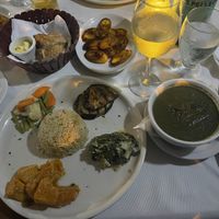 Veggies, rice, plantains, bread, and calaloo soup.  at The Fish Pot in Black Rock