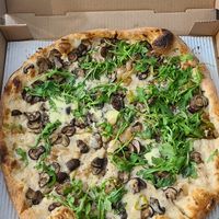 White pizza. Mushrooms, onions, garlic, arugula at Lucas Pizza in Selbyville
