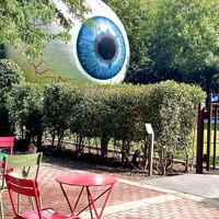 It’s located right next to the giant eyeball in downtown, and there are a few tables/chairs set up outside   at Starship Bagel in Dallas
