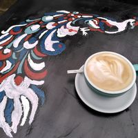 Oat milk latte and lovely peacock 🦚 (January 2023) at The Perky Peacock in York