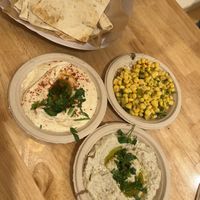 Corn salad, hummus, baba ghanouj, and pitas   at Gaililee Falafel & Shawarma in Lake Worth
