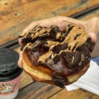 Dirt doughnut, covered with chocolate glaze, Oreo pieces and peanut butter drizzle at Voodoo Doughnut Tres in Eugene