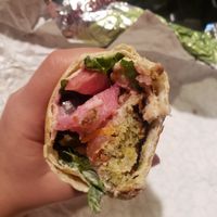 falafel, tomato, hummus, pickled veggies, mixed greens, and all rolled in fresh pita bread at Aladdin's Eatery in Mishawaka