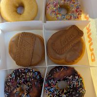 Original glazed, vanilla sprinkles, lotus biscoff bomb, and chocolate sprinkles at Dunkin' - Cornavin in Geneva