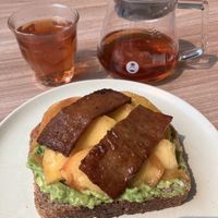 Avocado toast with peaches and tofu bacon   at Feast & Fallow in Vancouver