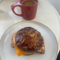 Egg and Cheese on pretzel Brioche Bun and an Americano with Oat Milk!  at Little Loaf Bakeshop in New Paltz