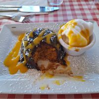 Fluffy vegan orange cake with warm chocolate sauce , orange sorbet and mango drizzle at Nancy's Barn in Ballyliffin