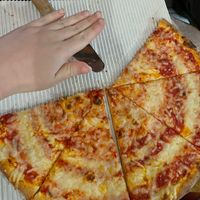 (three slices missing) in comparison to my hand for scale   at Sisters Pizza in San Diego