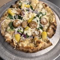 Cashew Alfredo base, onions, spinach, pineapple and beyond bratwurst pizza   at Humble Wood Fire Pizza in Gainesville