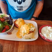 One Tomato, Two Tomato: a vegetarian take on eggs Benedict with fried green tomatoes as your "meat" and biscuits as your base. Grits on side. at Ruby Slipper Cafe in Pensacola