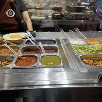 Mesa con ingredientes a escoger para el burrito  at Burritos - Ferran in Barcelona