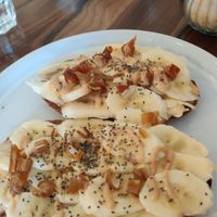 Peanut butter and banana toast topped with chia seeds and chopped up dates at Alma Kitchen & Coffee in Tangier