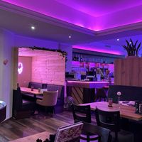 Tables and neon lights inside at Smashup! in Aachen