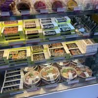 Vegan sushi boxes have a green shelf label  at Wasabi - Shaftesbury Ave in London