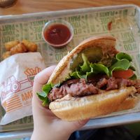 Classic burger with special sauce and small tator tots at Next Level Veggie Grill – Ballard in Seattle