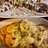 KOFTA KABOB (top) - Cinnamon and cumin infused “beef,” tahini, parsley, sumac
CONFIT POTATOES (bottom)- Lemon zest, garlic chips, parsley at Anixi in New York City