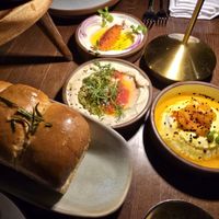 Layered Herb bread, 3 dips (Whipped Ricotta, Olive Tahini, Taramasalata) at Anixi in New York City