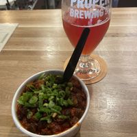 Vegan chili and a glass of sour ale 🍺.  at Proper Brewing & Burger Co in Moab