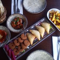 Vegan Mezze for two people: Aubergines with walnut-filling, muhammara (walnut parika dip), falafel, fried potatoes with garlic, spinach pouches, libanese bread (came with the meal) at Levant Grill in Falkoping
