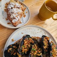 Mushroom on Sourdough, almond croissant and (an almost finished) oat Latte 🥰 at Faun in Malvern