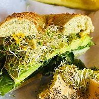 made to order bagel with avocado, sprouts, lettuce and spinach at Ozark Mountain Bagel Co - Central Ave in Bentonville