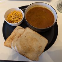 Misal pav, the vegan option comes with a choice of sliced bread or rice. The original bread bun is not vegan. at INDelicious Bistro in Prague