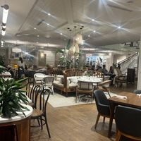 Indoor lobby restaurant seating and upstairs roof top dining  at Delish Sisters in Clemson