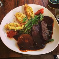 Homemade seitan medallions with stuffed potatoes, green beens and orange and rosemary sauce. at Bistro Bardot in Berlin