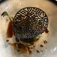 Vegan starter with scallop of celeriac and jackfruit as a substitute for the sea bass, with apple, soy and black beans  at De Brass Goes in Goes