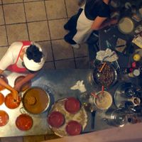 Chef Rita and her assistant, seen from above, preparing the food at Il Colibri in Calci