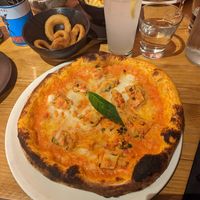 The vegan lasagne pizza with onion rings on the side at Nonna Said in Glasgow