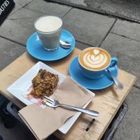 Oat milk chai latte and flat white with a flapjack. at Small Street Espresso in Bristol