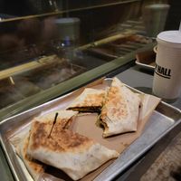 Crunch wraps, sitting on the floor. at Vegan Vibrationz in Plano