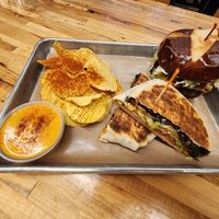 Black bean crunch wrap, bacon jalapeño cheddar burger, chips and queso at Vegan Vibrationz in Plano