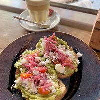 avocado ‘feta’ toast & turmeric latte  at Velo Cafe & Bar in Interlaken