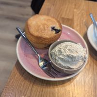 Blueberry muffin with extra cream at Velo Cafe & Bar in Interlaken