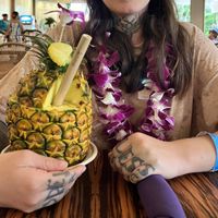  a mango vegan drink in a pineapple.   at Polynesian Cultural Center in Laiea