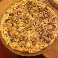 A classic flamenkueche — lots of mushrooms and La Vie ‘bacon’ on a lactofermented soy cream  at L'Alsacien République in Paris