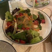 Glass noodle salad with spicy lime 🍋‍🟩🥗🍅dressing on a bed of lettuce.   at Vegan Plate in Chicago