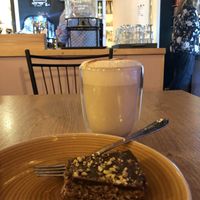 Oat chai latte and vegan raw cake  at Café Huskies in Longyearbyen