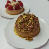 Pistachio cake, with raspberry marzipan in the background at Cream Dream in London