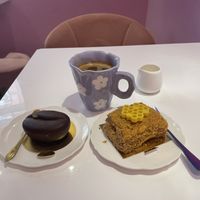 Vegan chocolate & caramel pastry and Ukrainian honey cake. Americano with oat milk on the side   at Cream Dream in London