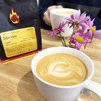 Perfect coffee with oat milk in cosy Letters&Numbers coworking. In the background is a package of coffee that I chose from a coworking coffee shop. The coffee was in beans, but they ground it for me there, it was so sweet! at Letters and Numbers in Yerevan