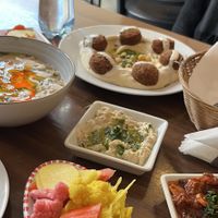 foul mdamas, hummus falafel, baba ganoush, pickled vegetables  at Palestinian Restaurant - Spalena in Prague