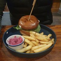 Chicken style plant-based patty with Louisiana cornbread coating, BBQ sauce, vegan mayonnaise, lettuce, red onion with a side of pickled red onions & chips (ve) at The Old Boat House in Manchester